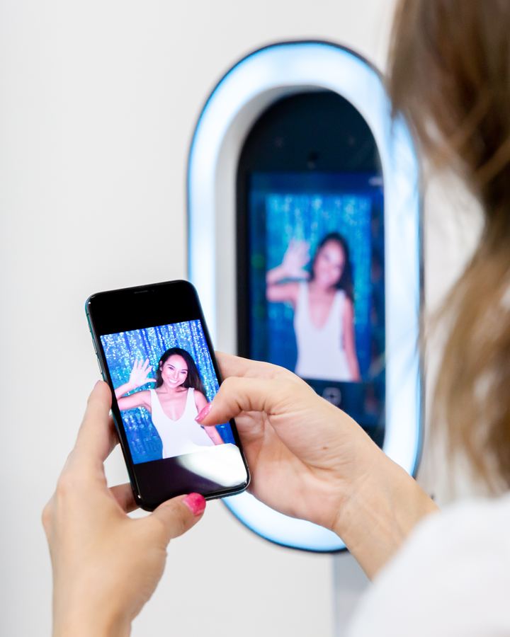 A guest saving her booth photo to her phone